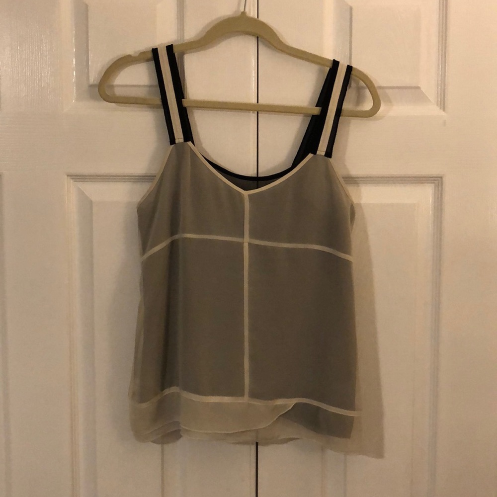 Cream over black tank